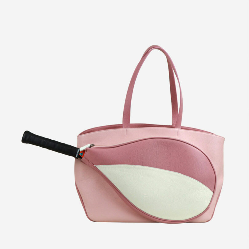 Pink tote bag with a tennis racket-shaped pocket attached on the front.