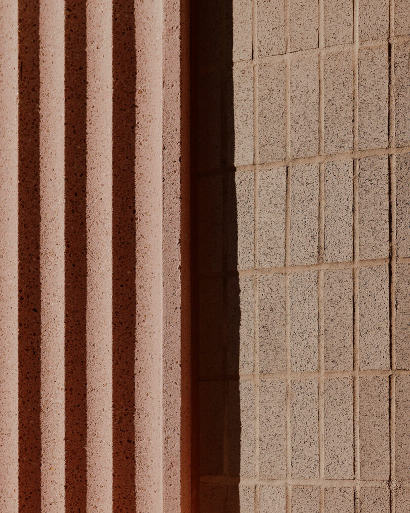 Close-up of two contrasting textures: vertical ridged surfaces on the left and a grid pattern on the right, illuminated by angled light casting shadows.