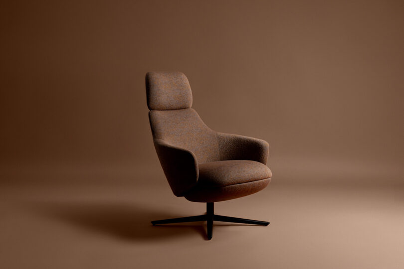 A brown upholstered swivel chair with a high backrest set against a plain brown background