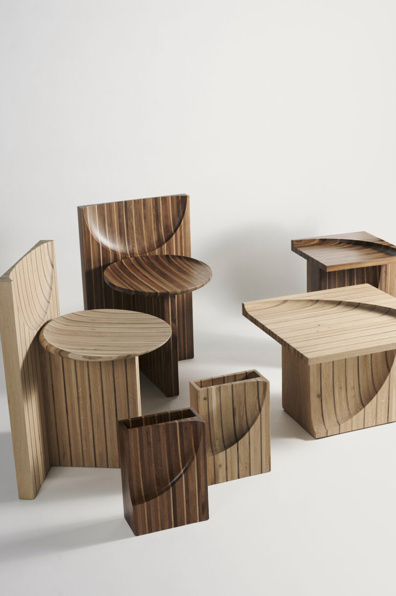 A collection of wooden tables and stools with various geometric shapes and patterns, arranged on a neutral background