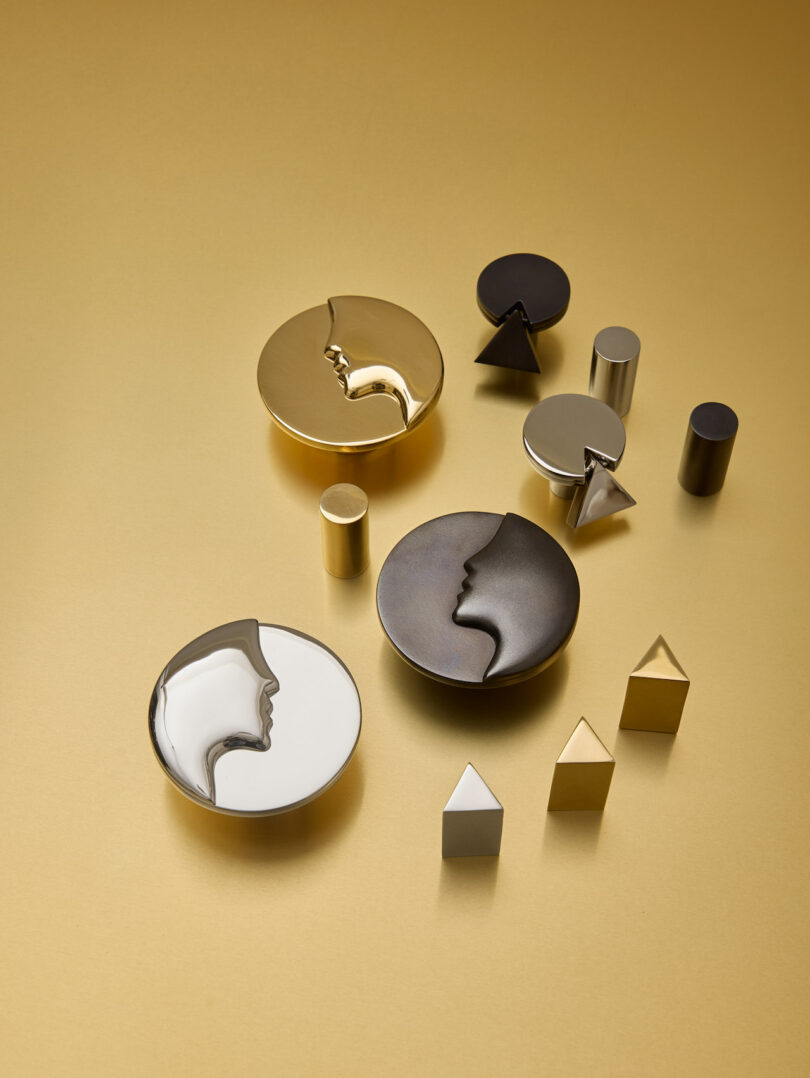 A collection of gold, silver, and black geometric hardware on a gold background