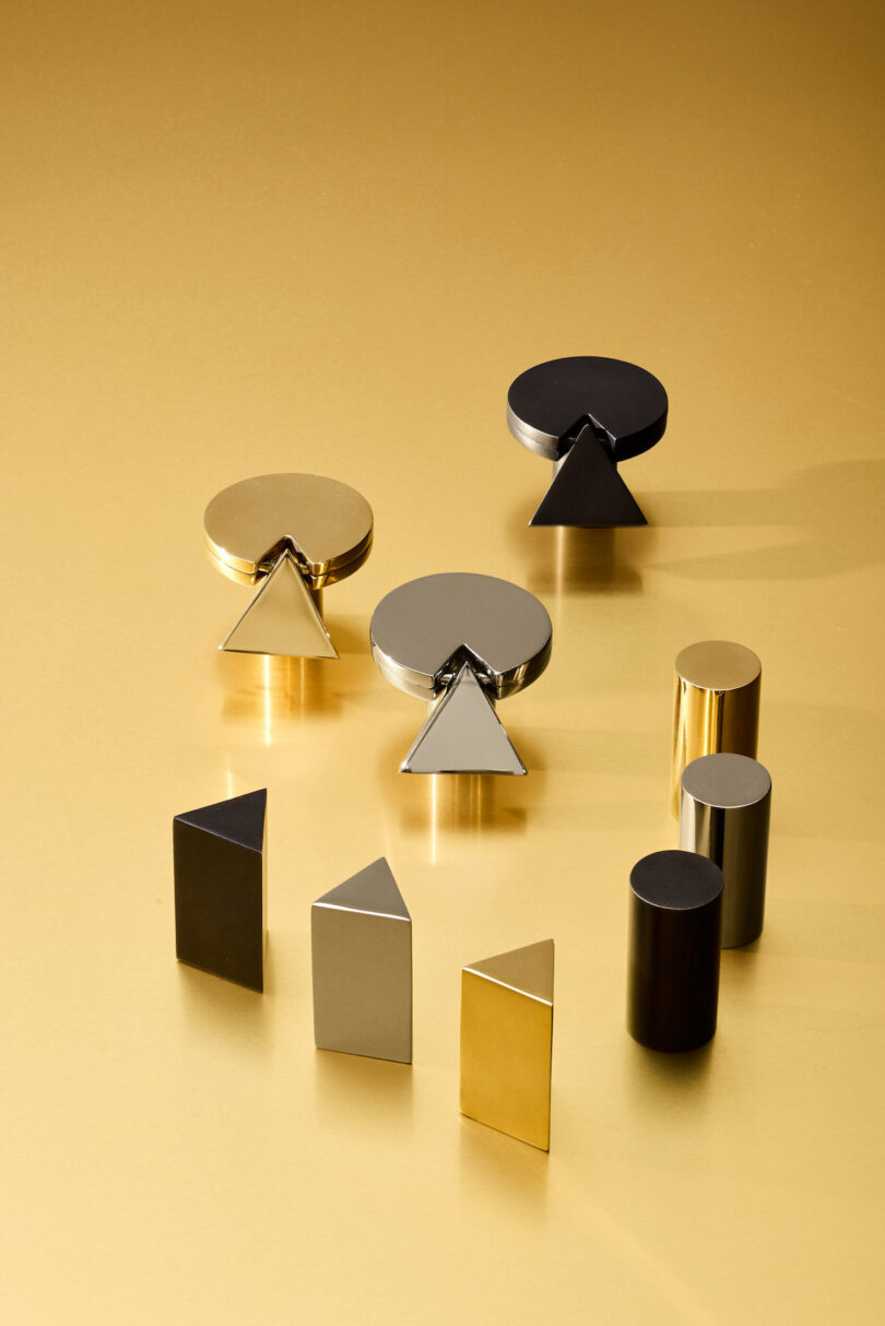 A collection of gold, silver, and black geometric hardware on a gold background