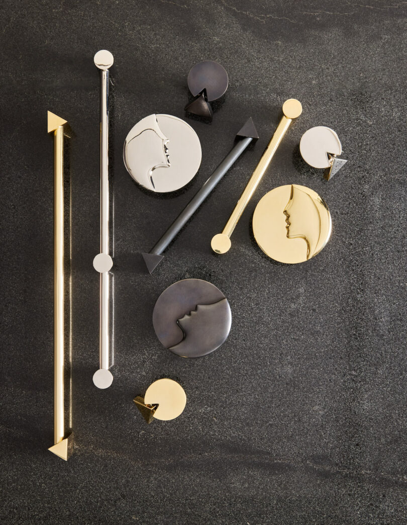 A collection of gold, silver, and black geometric hardware on a charcoal background