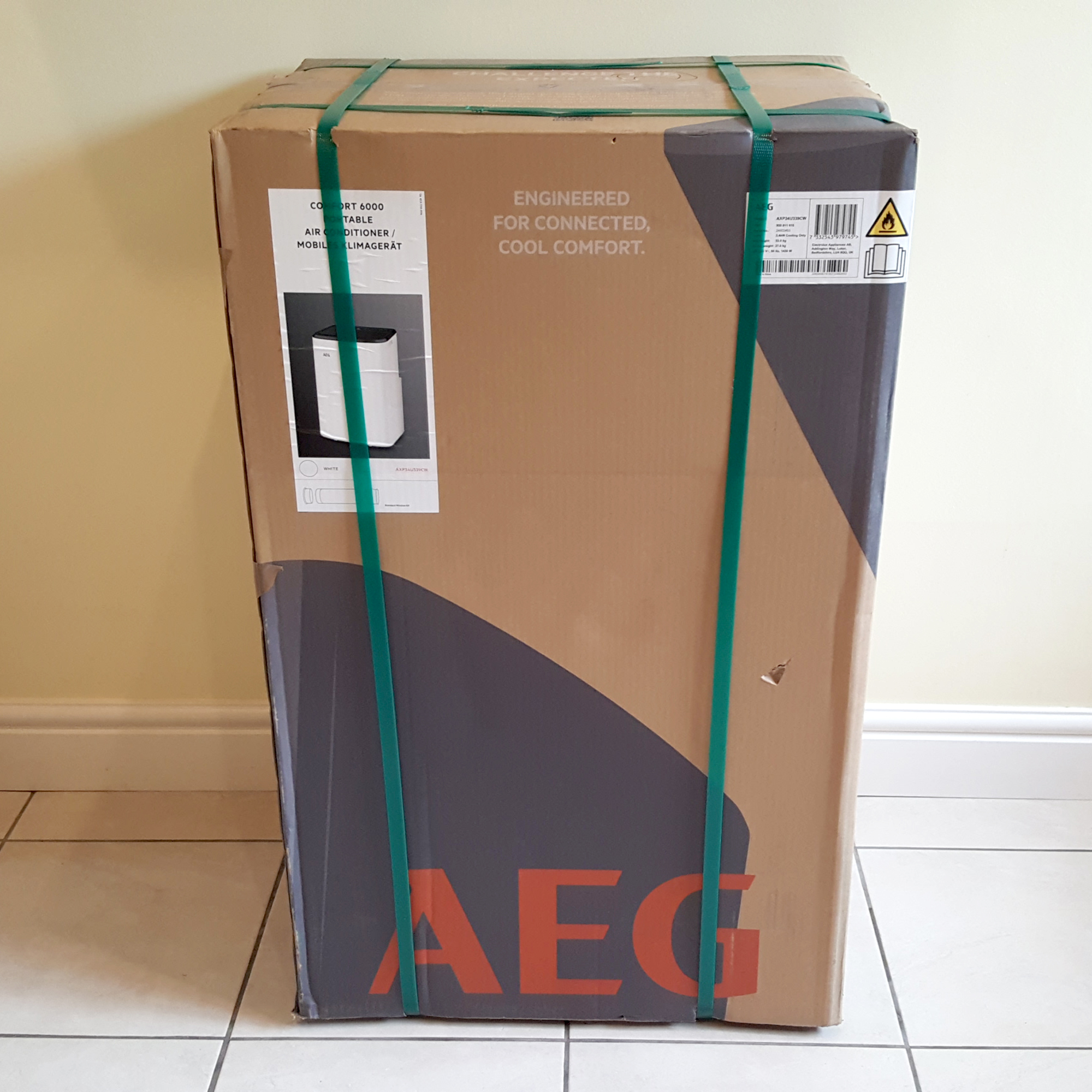 The AEG Comfort 6000 Portable Air Conditioner being tested in a room with green carpet
