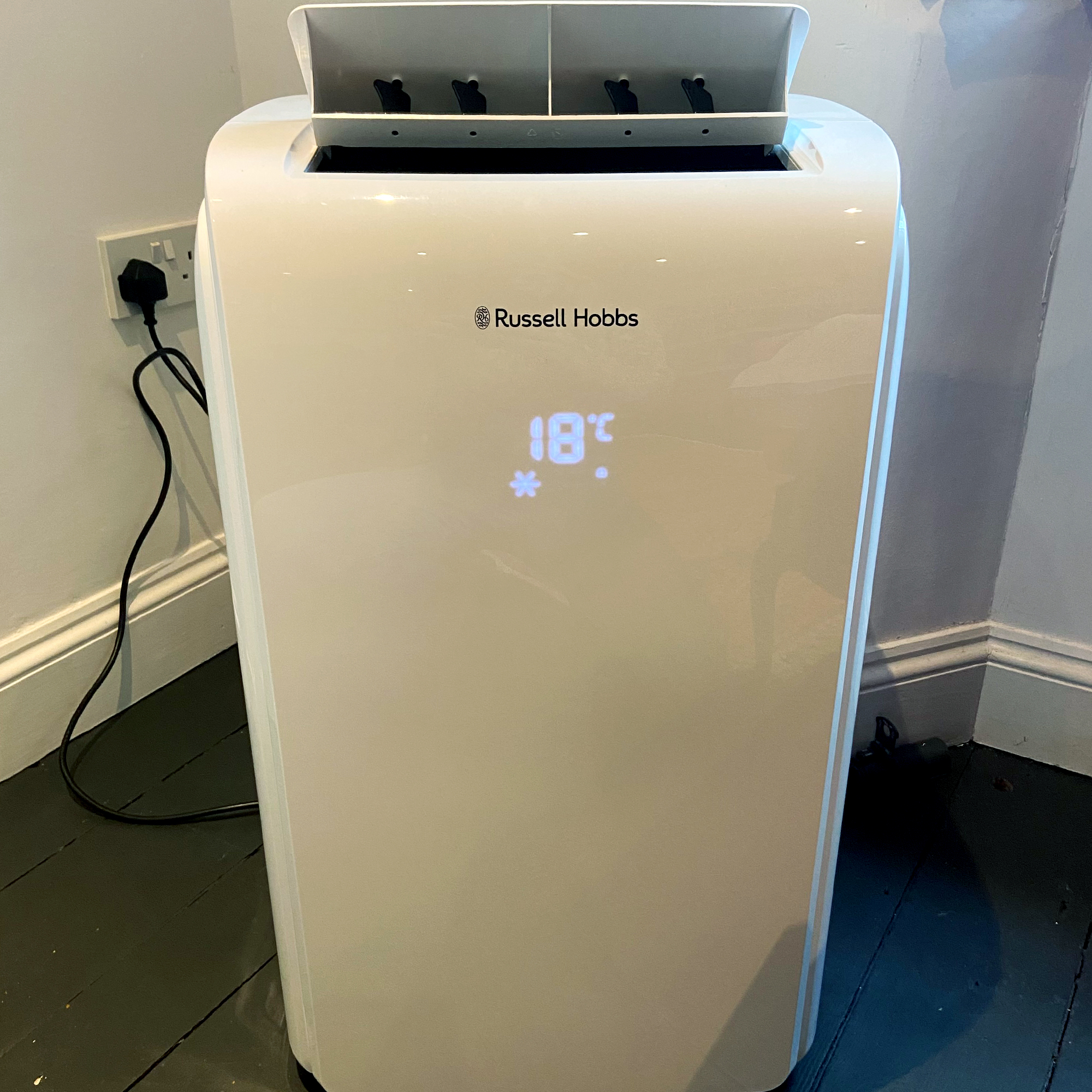 The Russell Hobbs RHPAC11001 Portable Air Conditioner showing 18 degrees illuminated on its display panel
