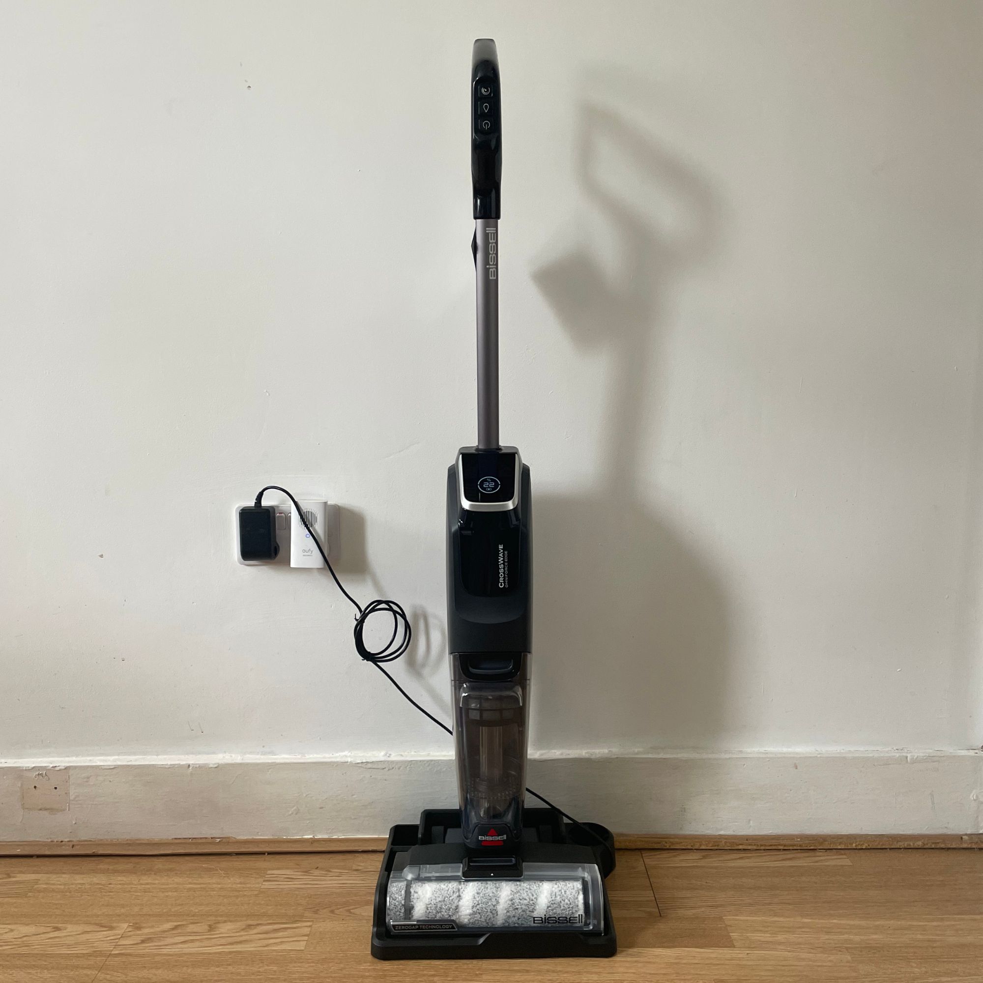 Bissell Crosswave Omniforce Edge standing against a white wall
