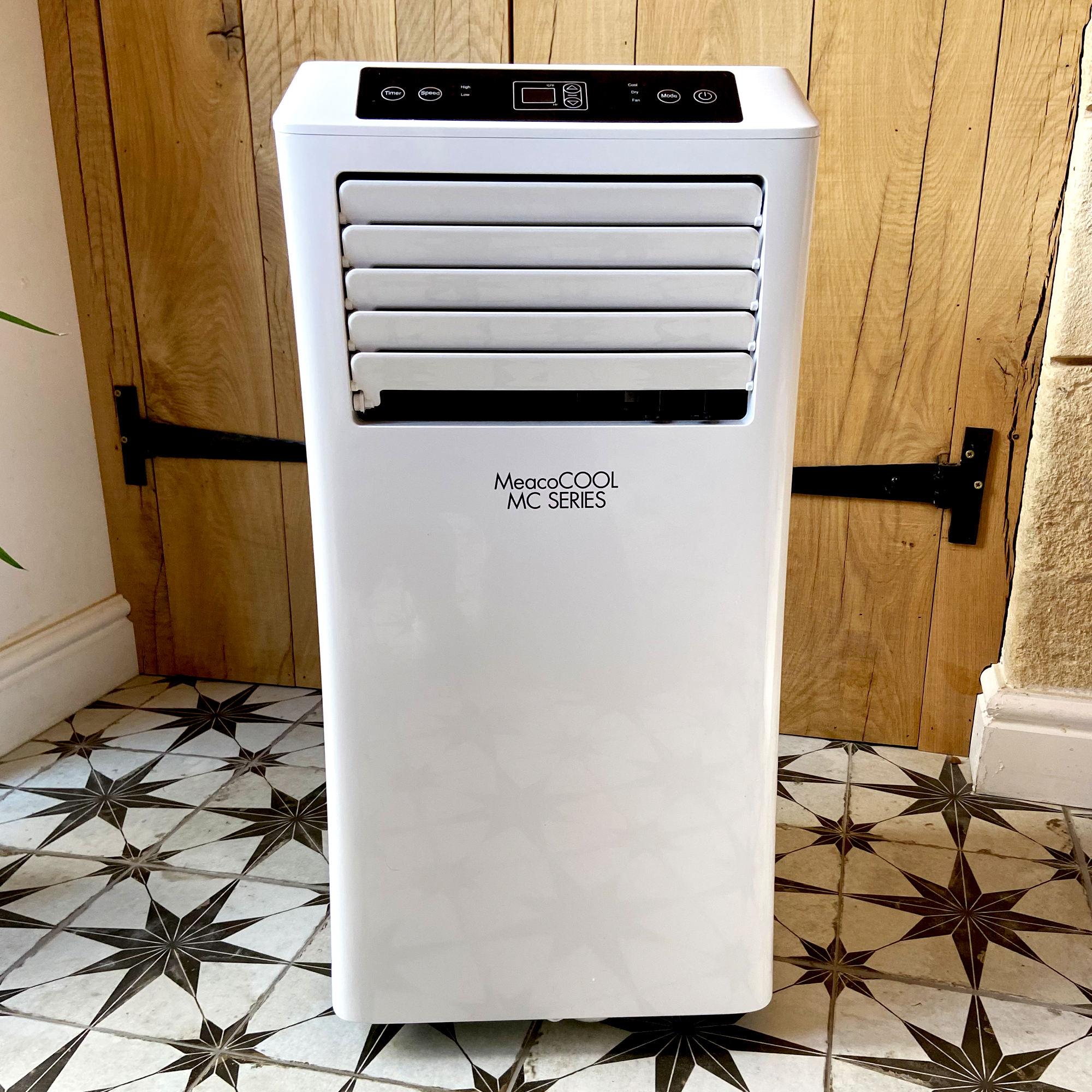 The MeacoCool MC Series 7000BTU Portable Air Conditioner  on a white tiled floor with grey star design