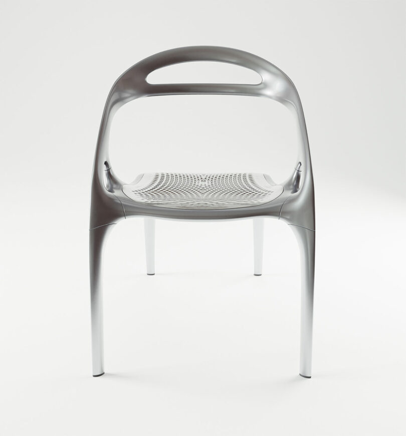A modern, metallic PolarisGo chair with a perforated seat and an oval cutout in the backrest, set against a plain white background.