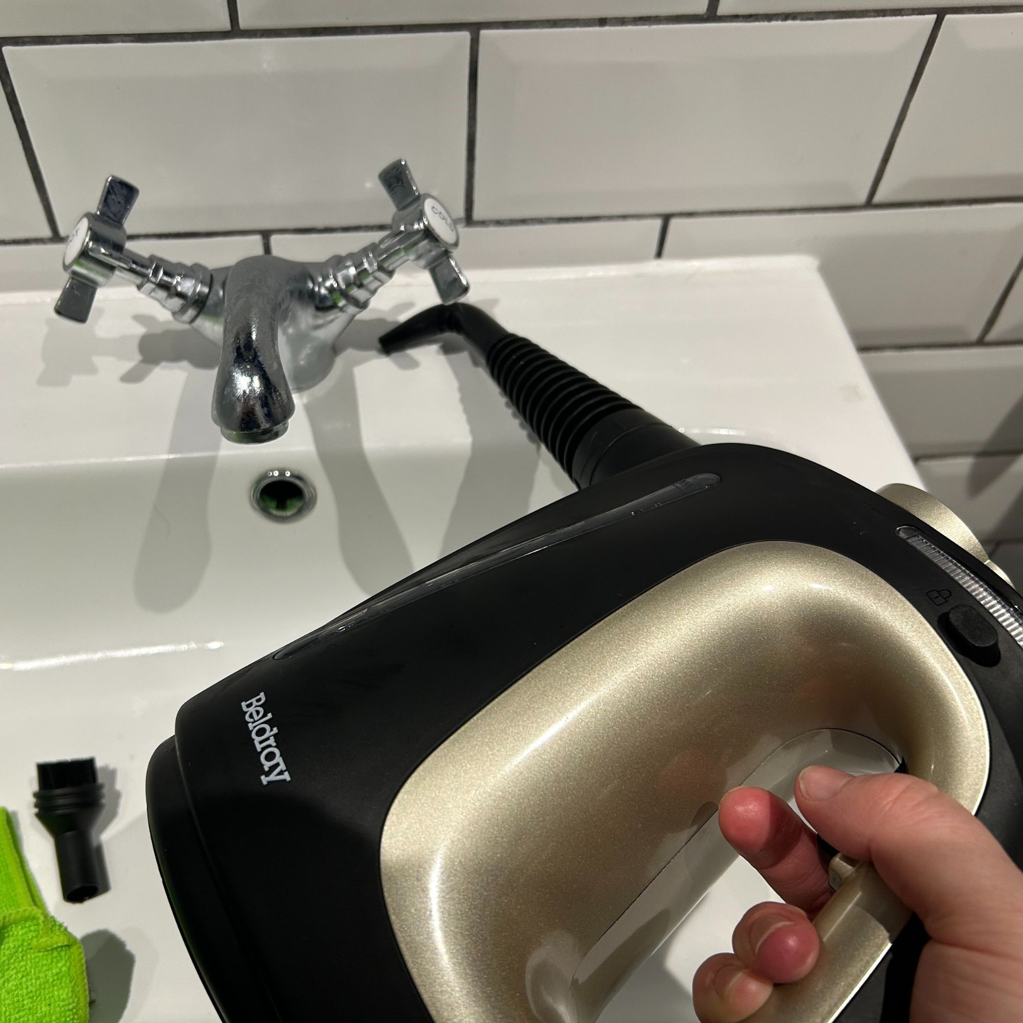 Beldray steam cleaner with angled nozzle cleaning bathroom sink