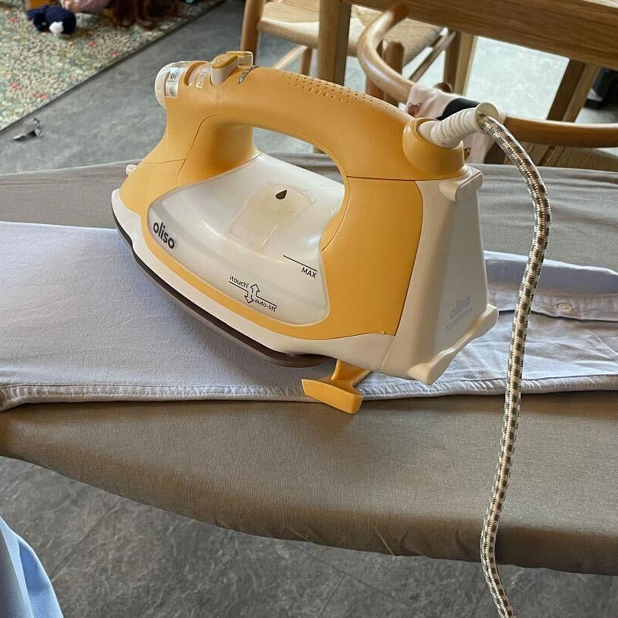 oliso iron on ironing board featuring lift function