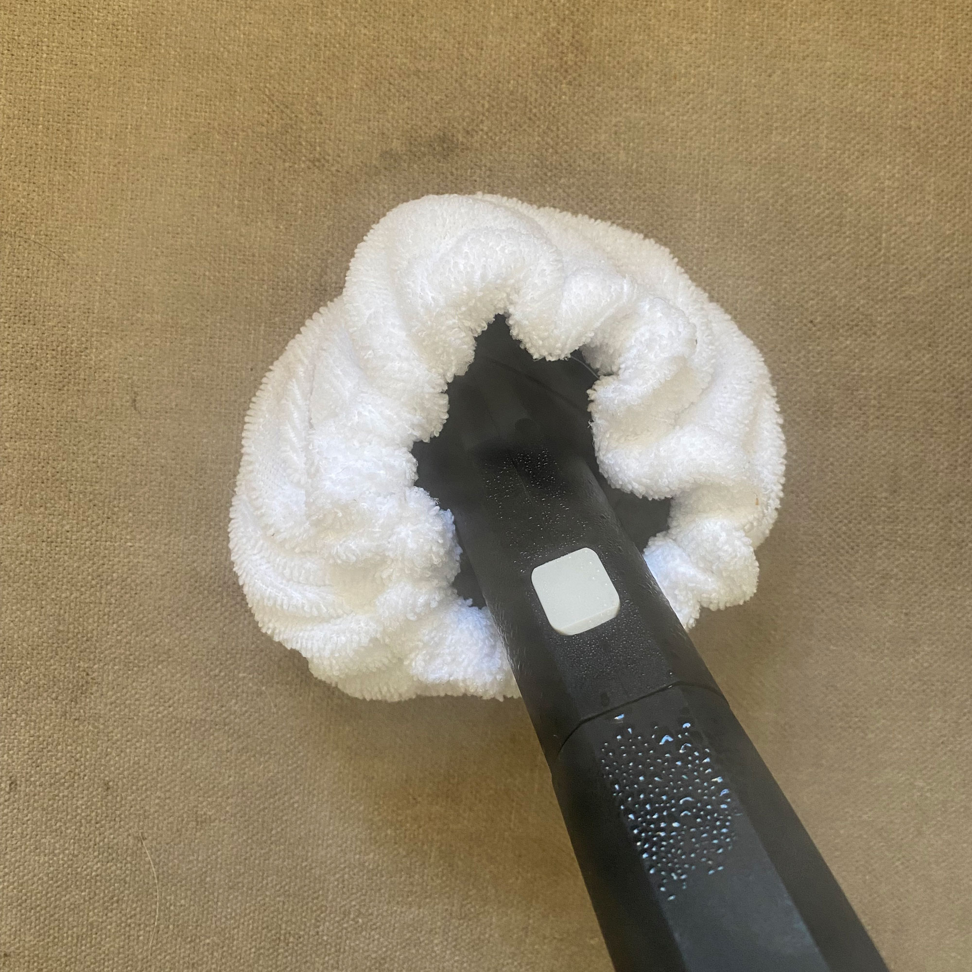 using dupray neat steam cleaner on grey sofa