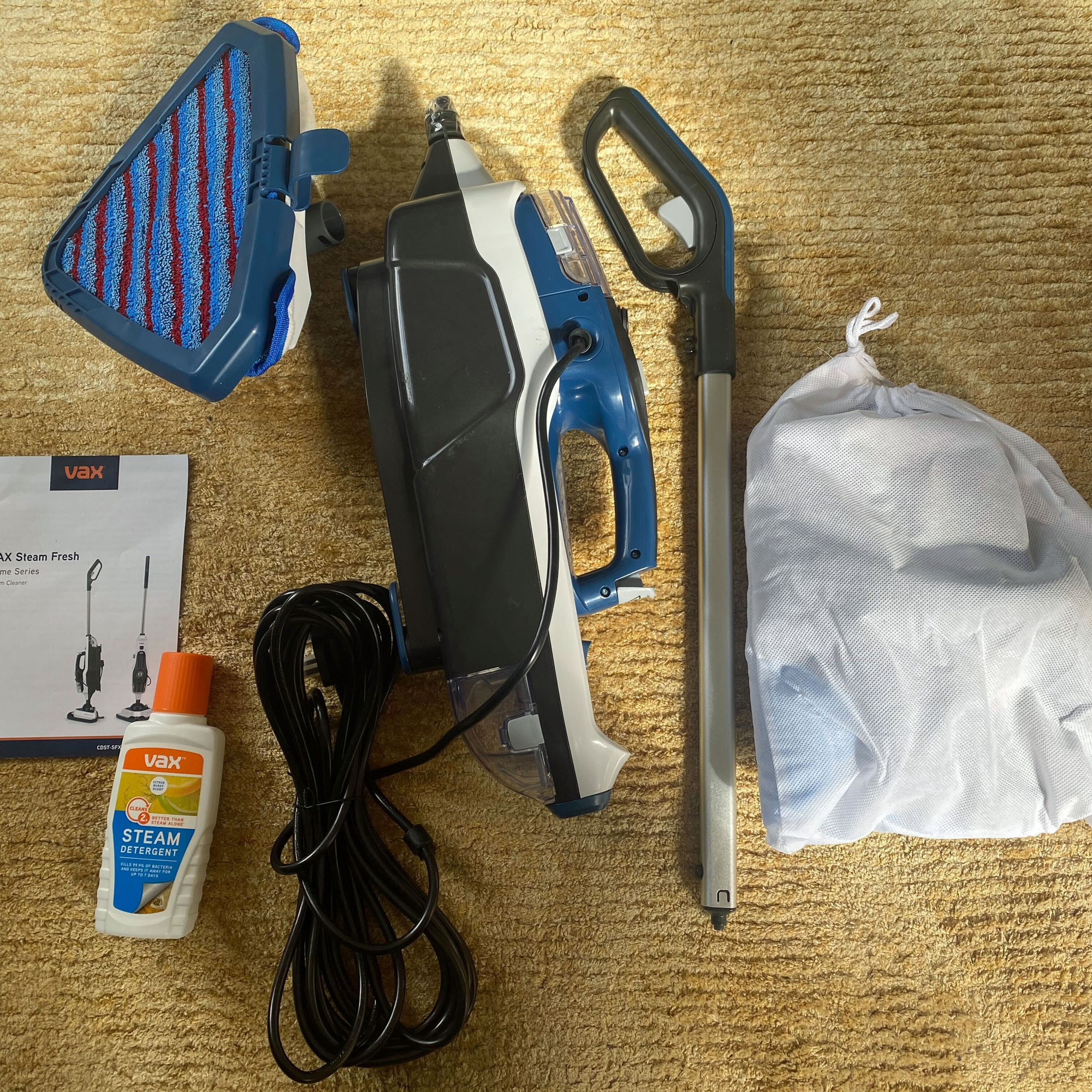 VAX steam fresh total home steam cleaner parts on a rug